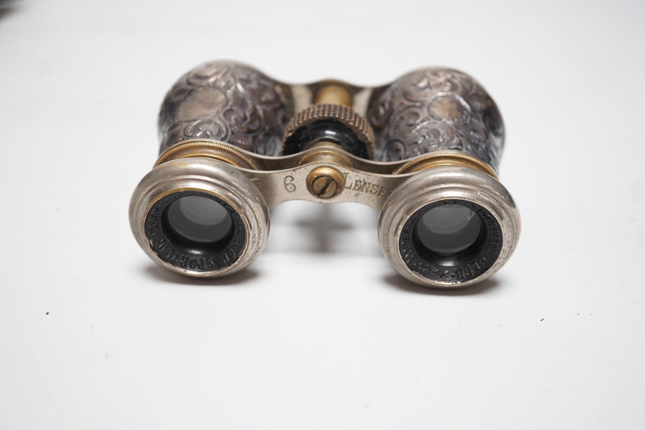 A pair of late Victorian repousse silver mounted brass opera glasses, Birmingham, 1900, (cased)